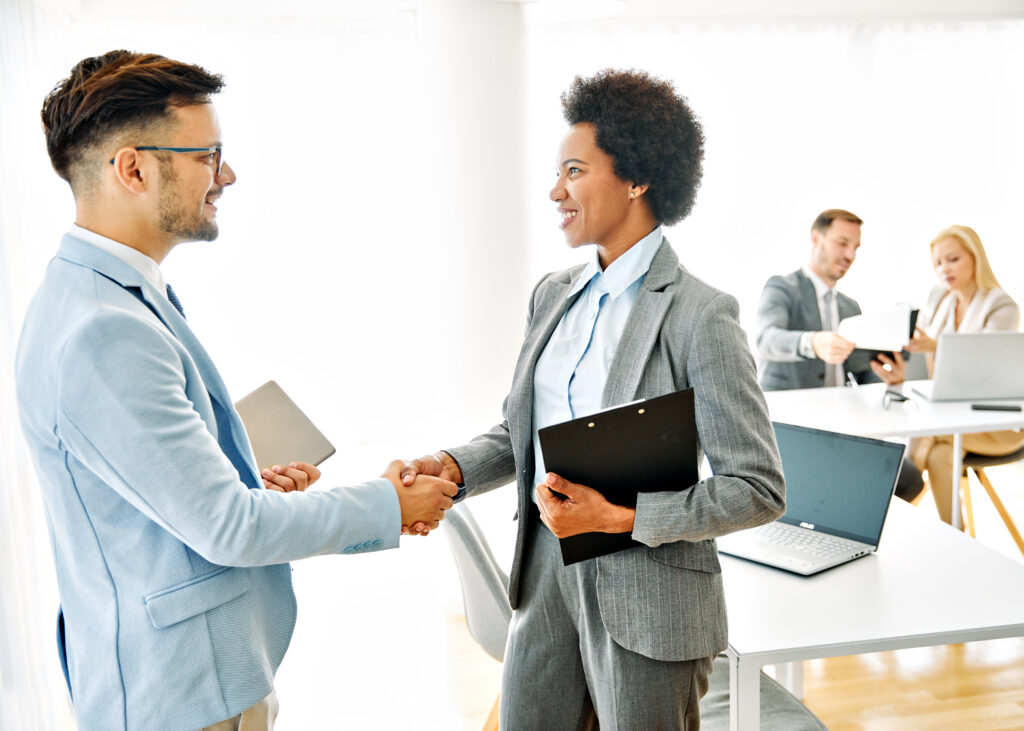 Two business professionals shaking hands after a successful negotiation.