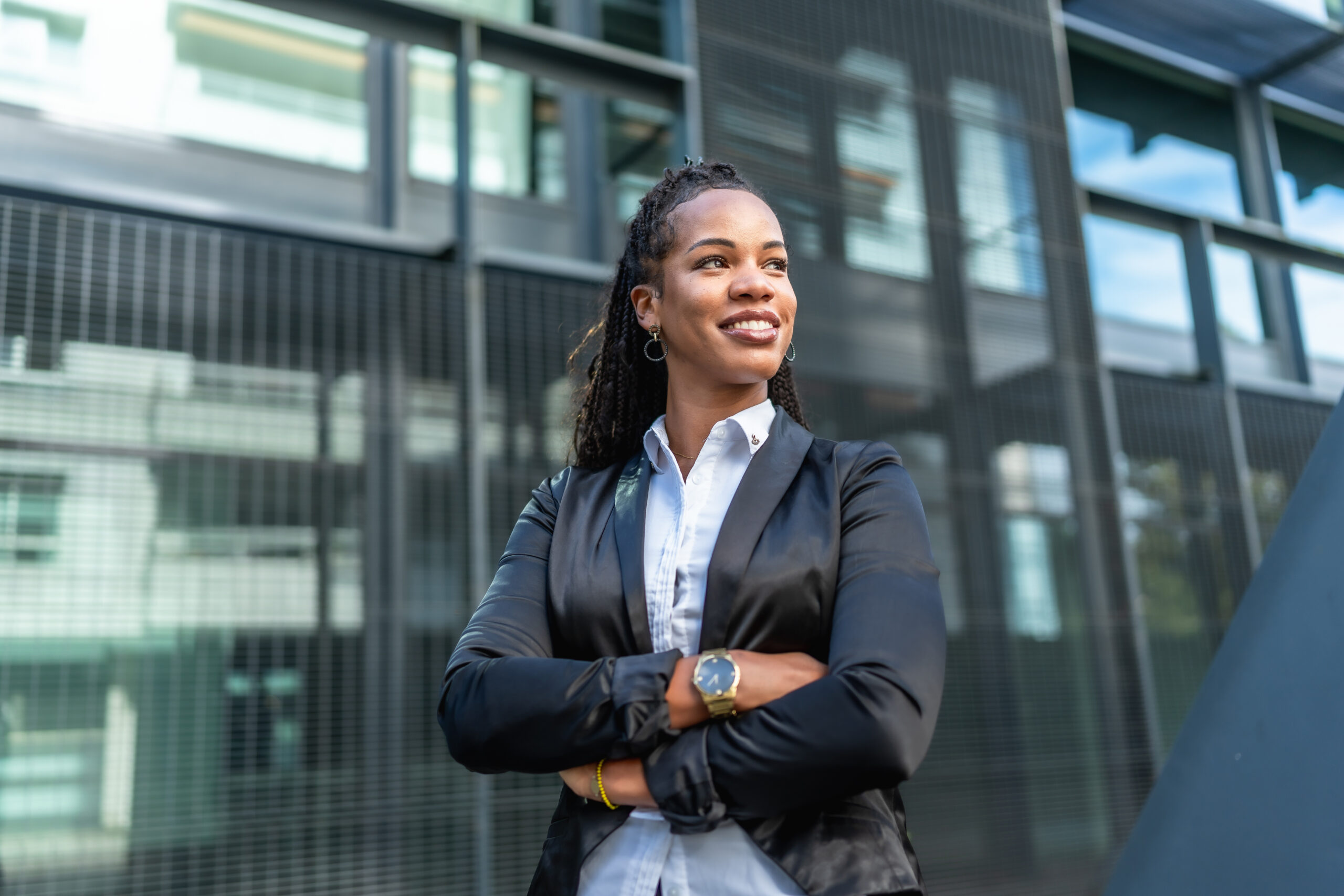 A corporate professional standing confidently outside the office.
